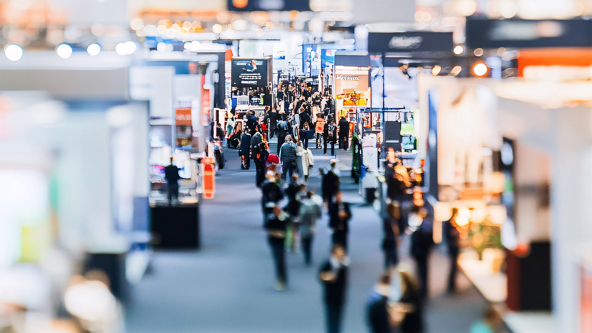 Busy exhibition hall with people visiting stands