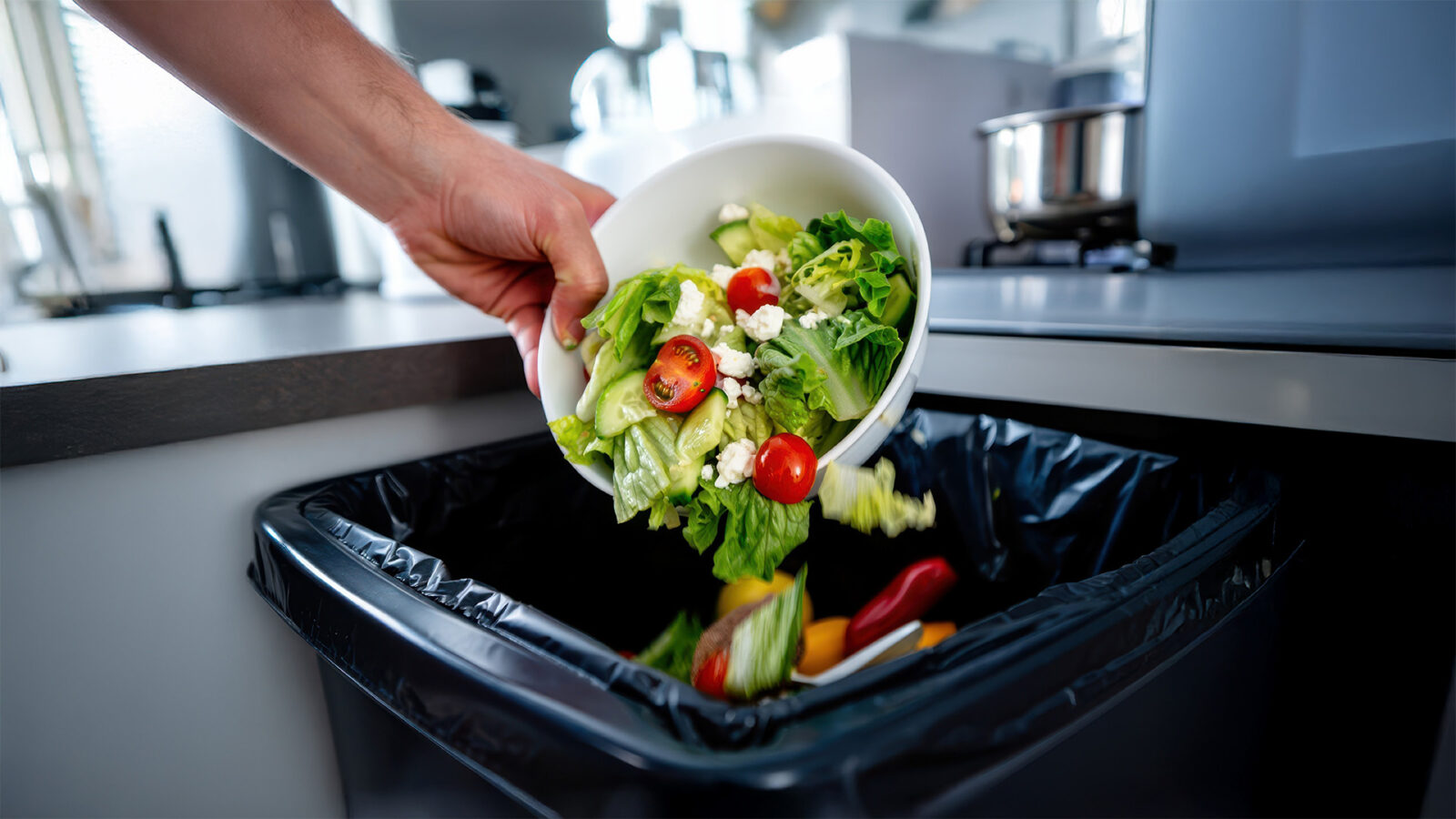 Image of a salad going into the bin