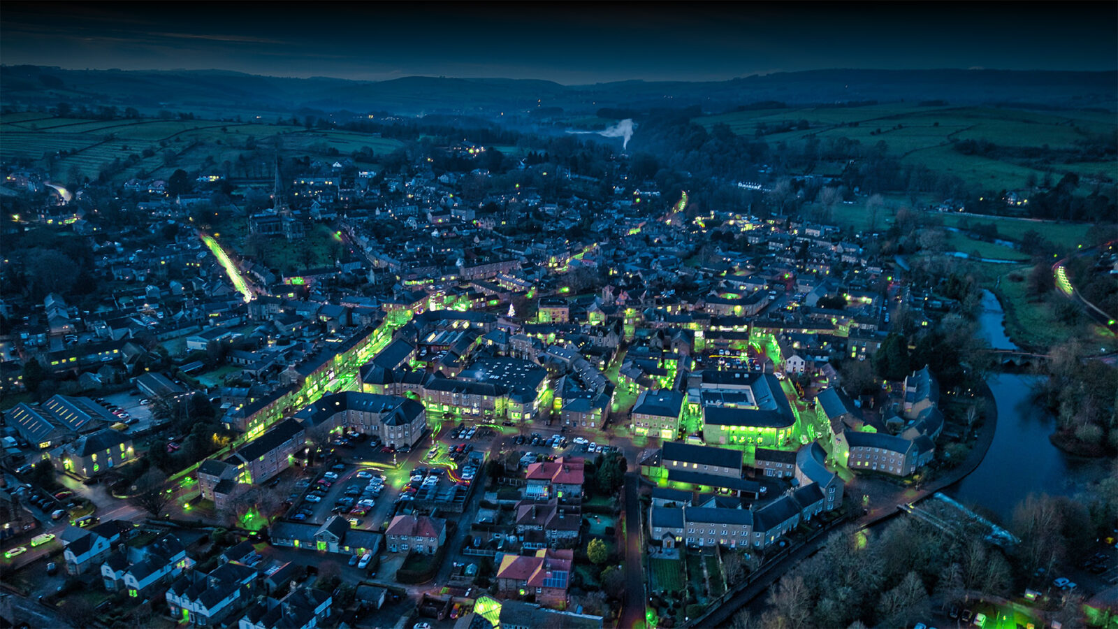 aerial shot of city with glowing street lights