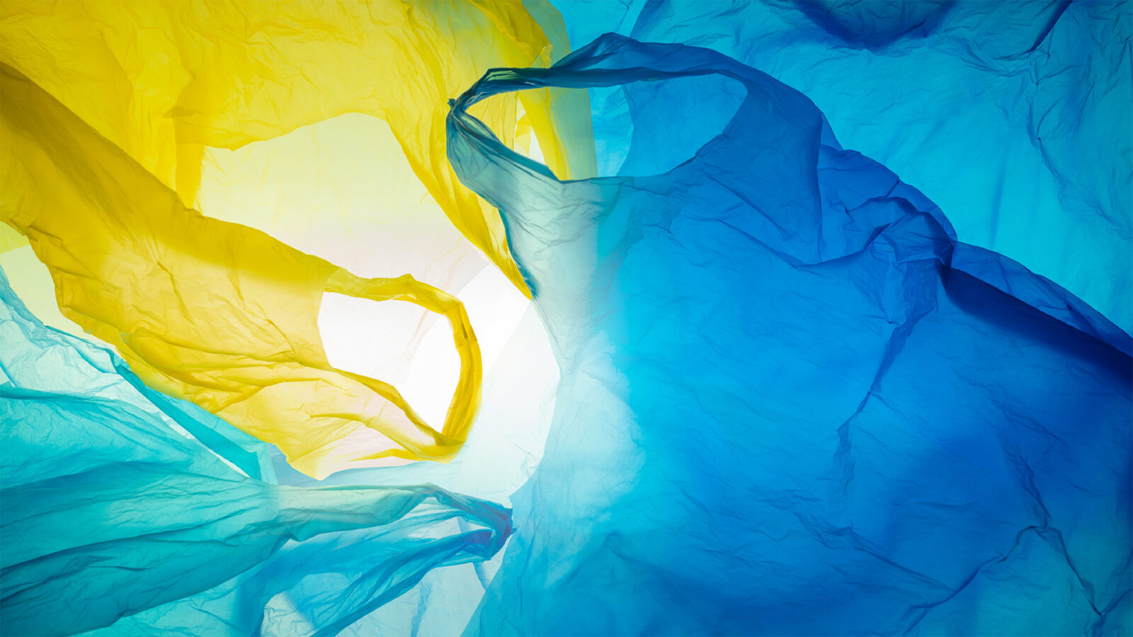 colourful disposable plastic bags background, crinkled and jumbled structure, plastic waste pollution