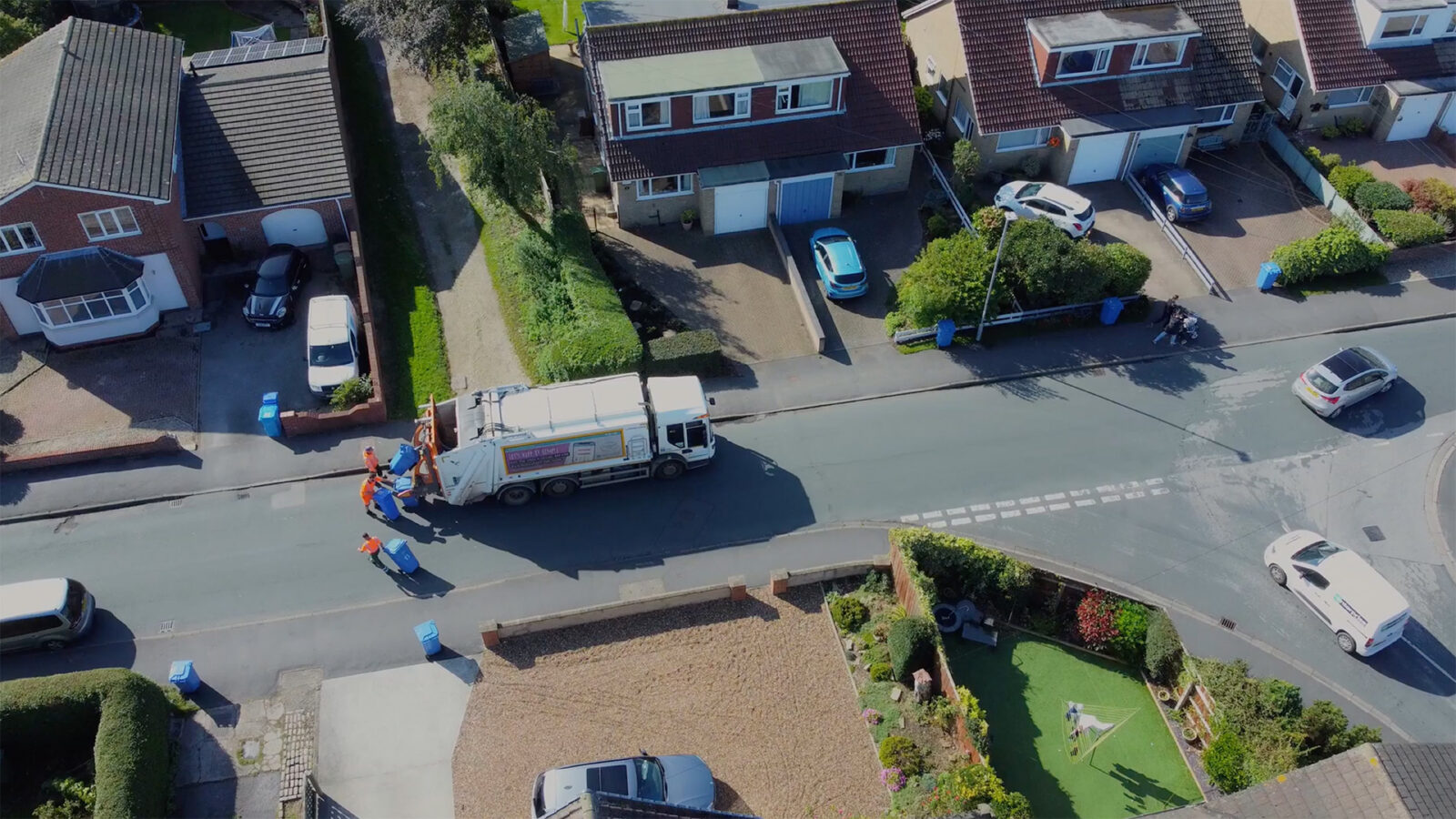 Drone. Waste collection truck in urban street collecting trash. Filmed. Yorkshire.UK.