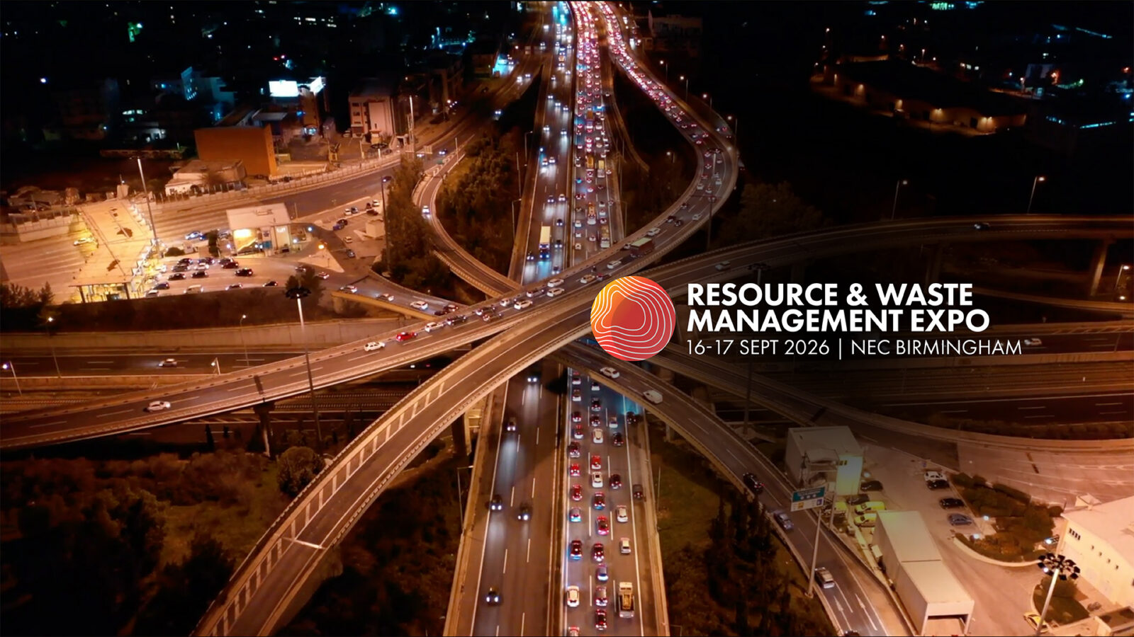 Aerial drone high speed night video of urban elevated road junction and interchange overpass in city with light traffic
