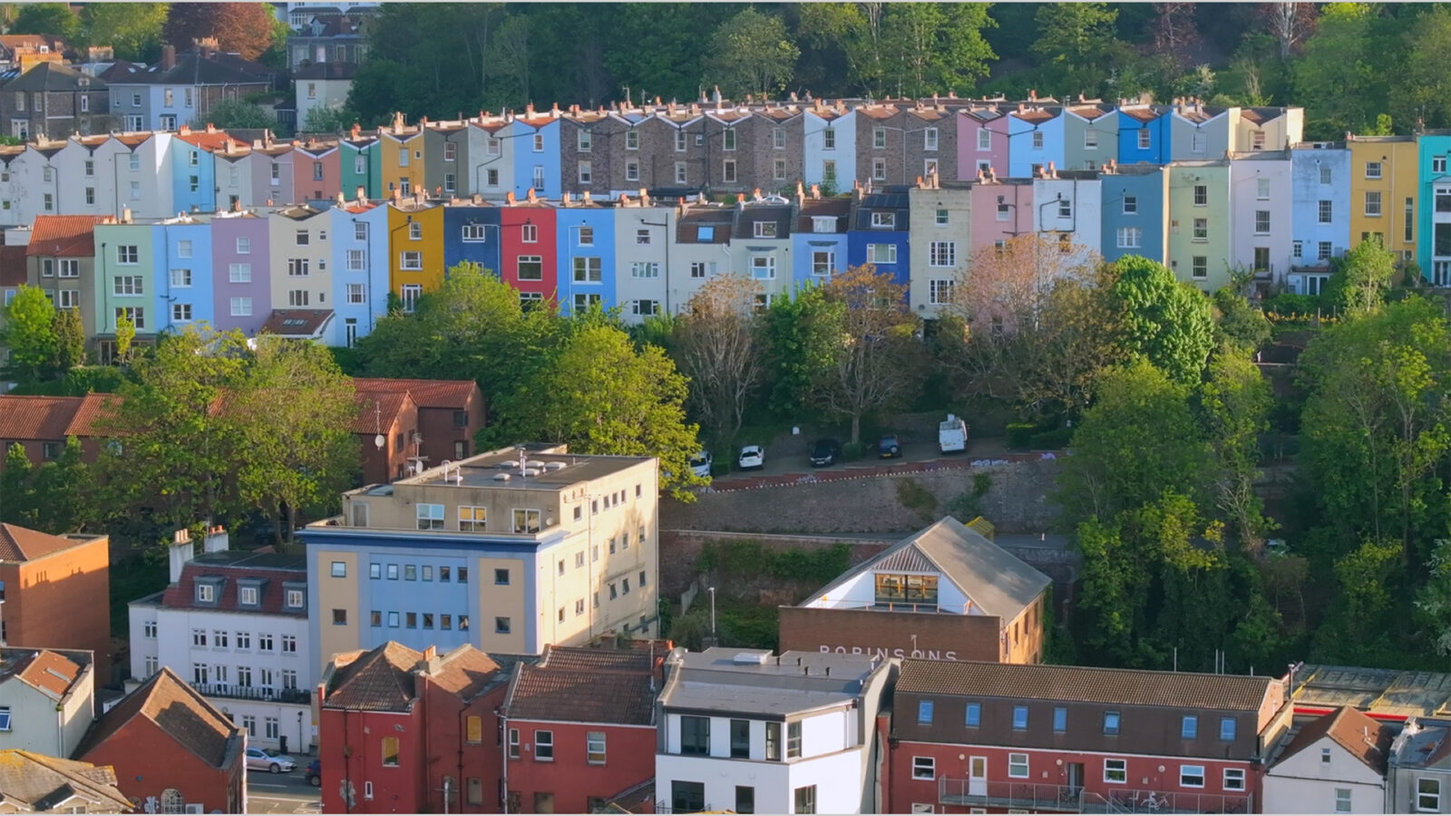 Aerial video of Bristol cityscape in the southwest of England featuring pastel coloured houses.